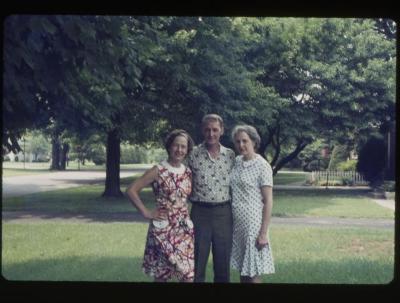 Two women and a man standing outdoors