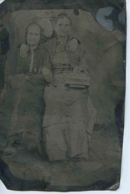 Two women, third person obscured