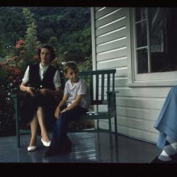 Mother and son sitting on porch