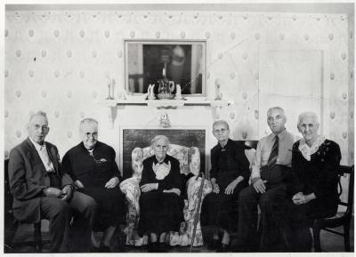 Group of people sitting in front of fireplace