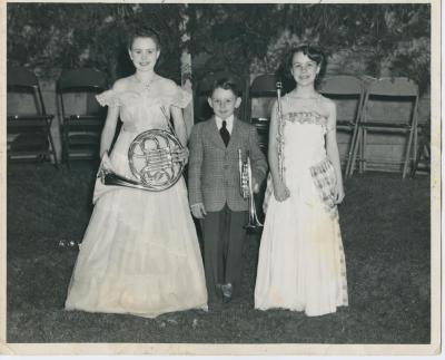 Two  young girls and a young boy holding musical instruments
