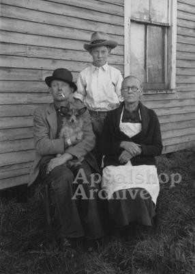 Portrait of woman, adolescent and man holding dog