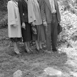 Group portrait, two holding eyeglasses